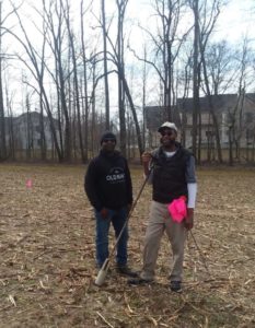 Two men marking land contours